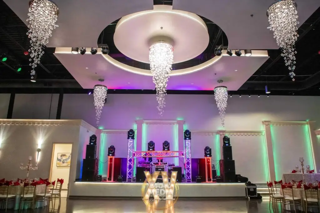 Elegant entertainment stage positioned front and center in a luxurious ballroom, featuring state-of-the-art lighting and sound for captivating performances at any event