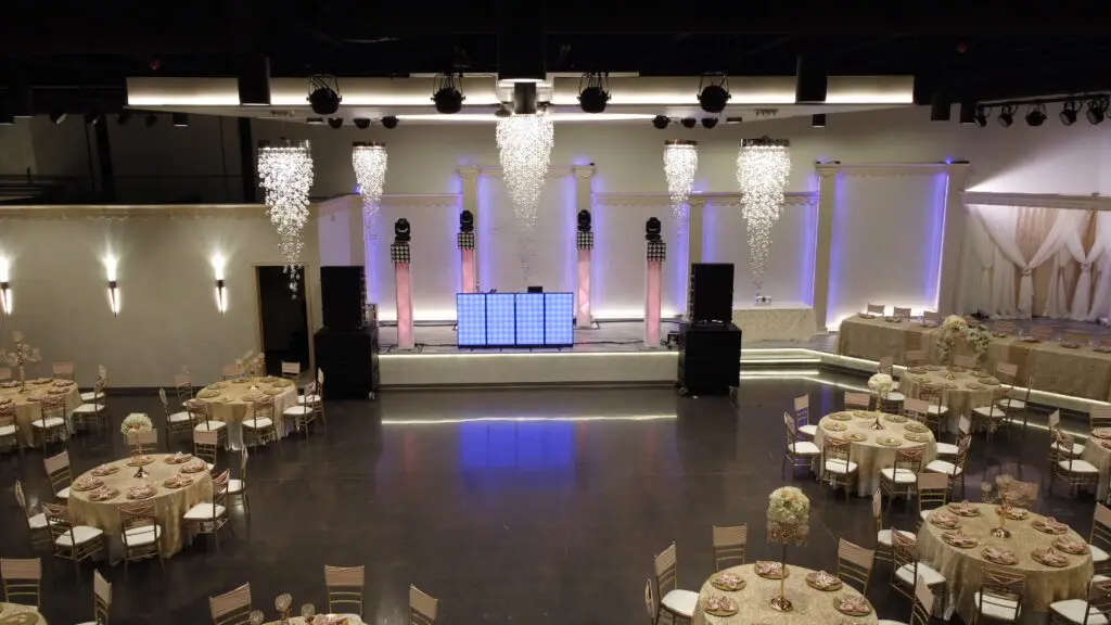 Elegant entertainment stage positioned front and center in a luxurious ballroom, featuring state-of-the-art lighting and sound for captivating performances at any event.