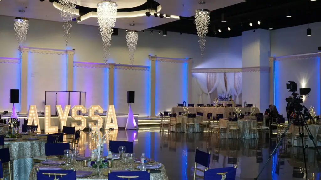 Elegant entertainment stage positioned front and center in a luxurious ballroom, featuring state-of-the-art lighting and sound for captivating performances at any event.